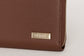 Pairre 4P brown leather passport wallet - close up of PVD gold Pairre hardware plate