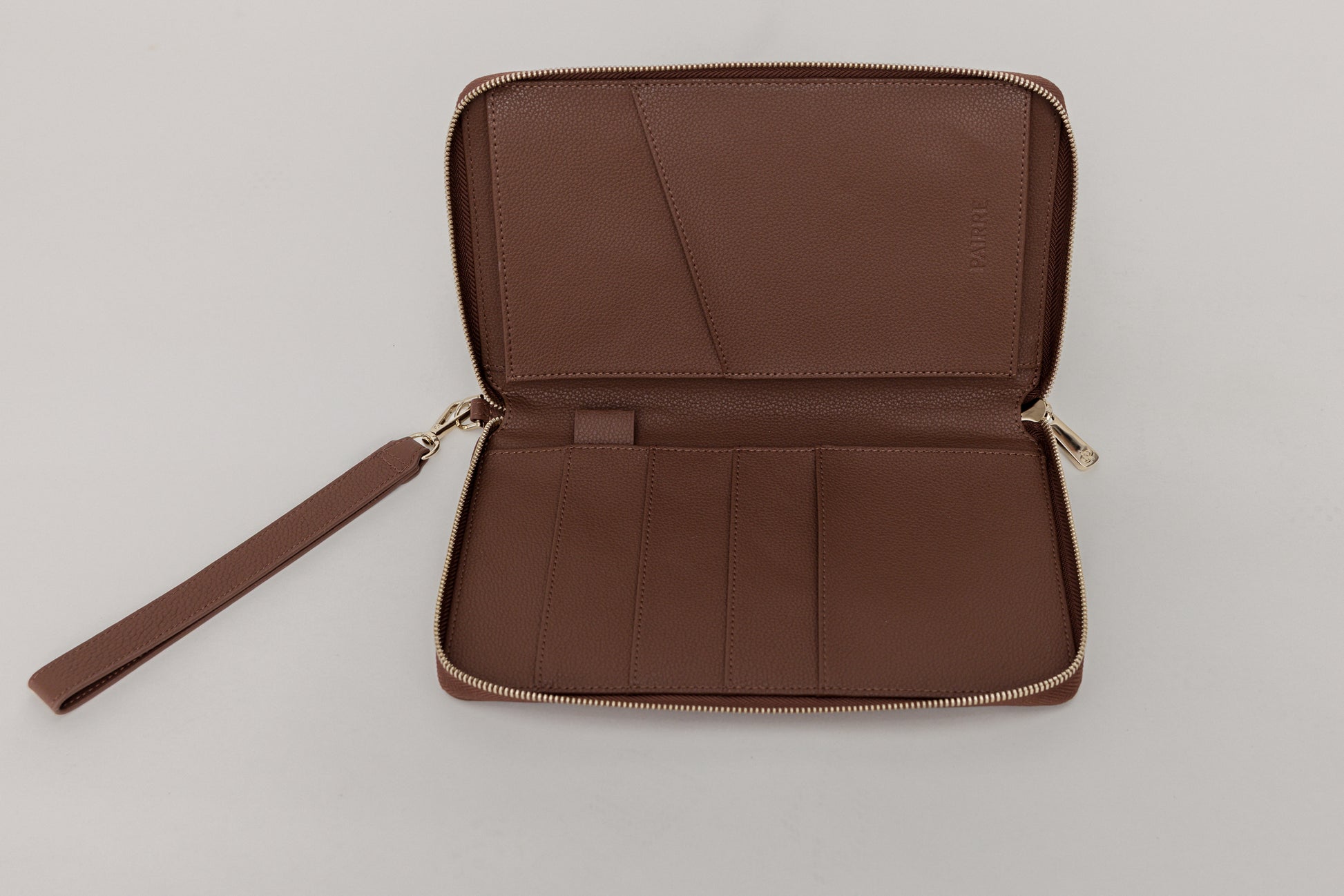 Pairre 4P passport wallet in brwn leather — open interior showing four passport slots and boarding pass pocket