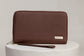 Pairre 4P passport wallet in brown full-grain leather — closed exterior showing PVD gold hardware Pairre 4P passport wallet in brown full-grain leather — closed exterior showing PVD gold hardware