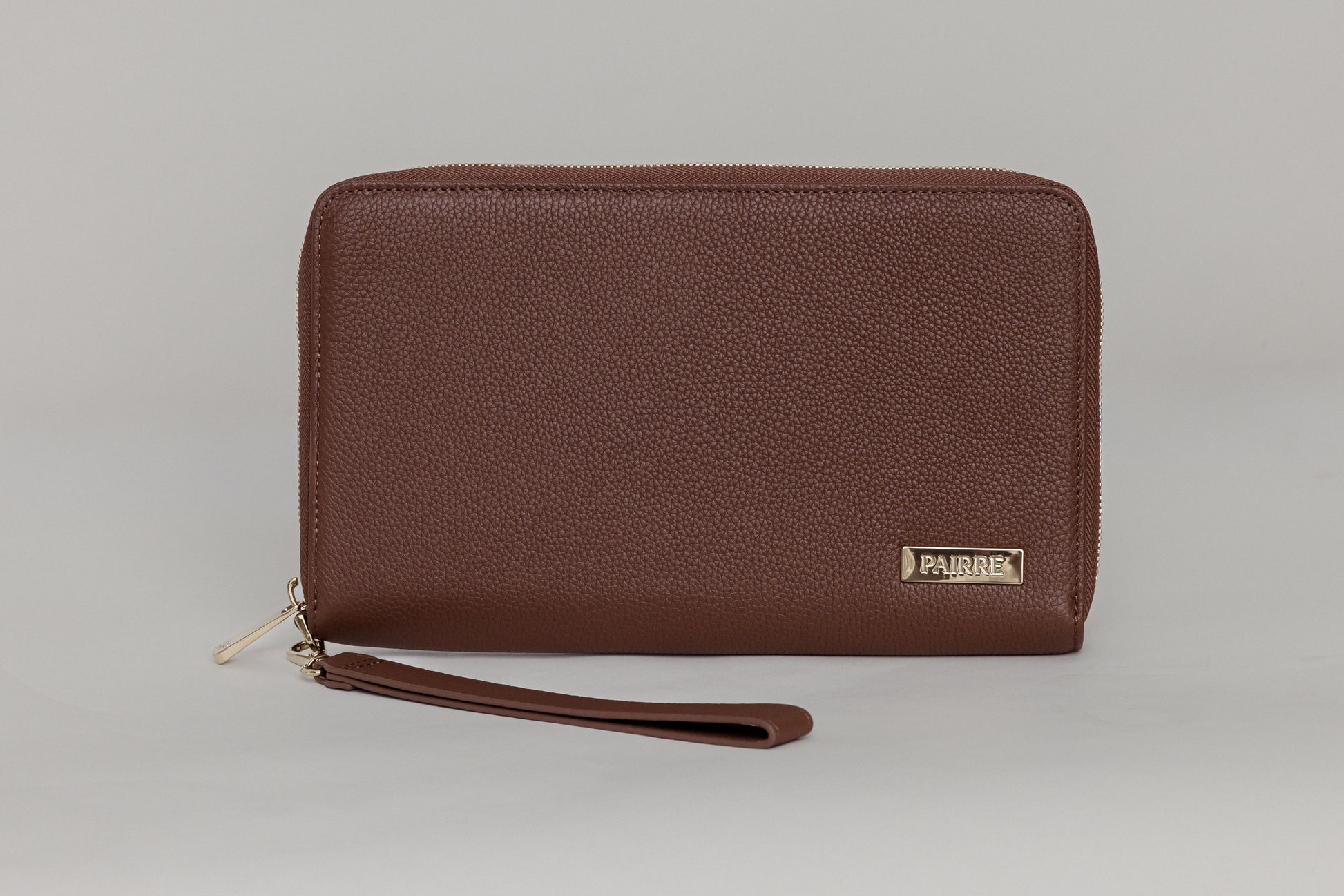 Pairre 4P brown leather passport wallet - close up of PVD gold Pairre hardware plate