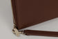 Pairre 4P passport wallet in brown full-grain leather — closed exterior showing PVD gold hardware