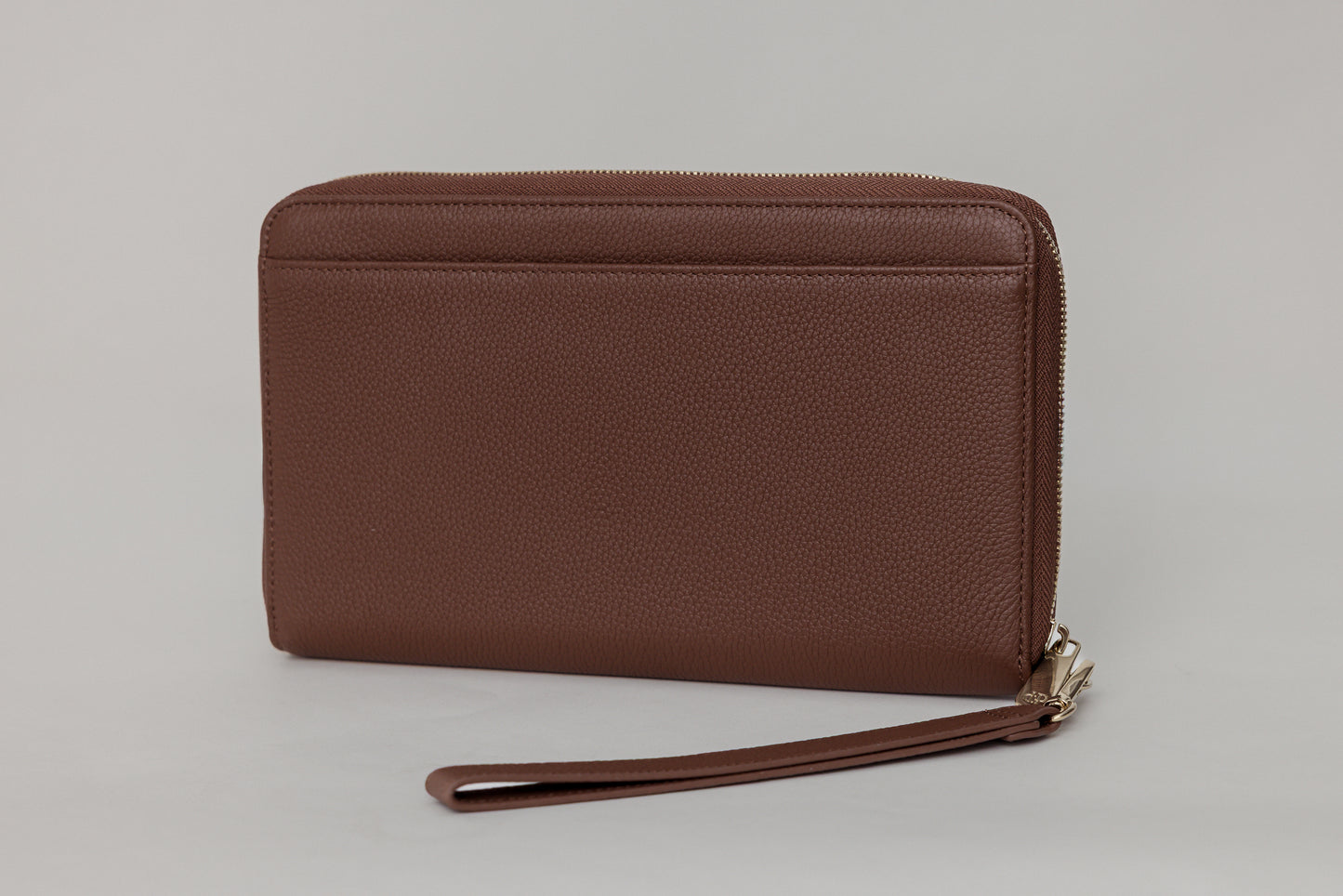 Pairre 4P passport wallet in brown full-grain leather — closed exterior showing PVD gold hardware - rear slip pocket
