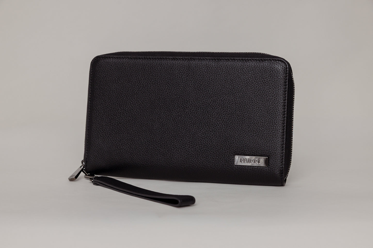 Pairre 4P passport wallet in black full-grain leather — closed exterior showing PVD gold hardware