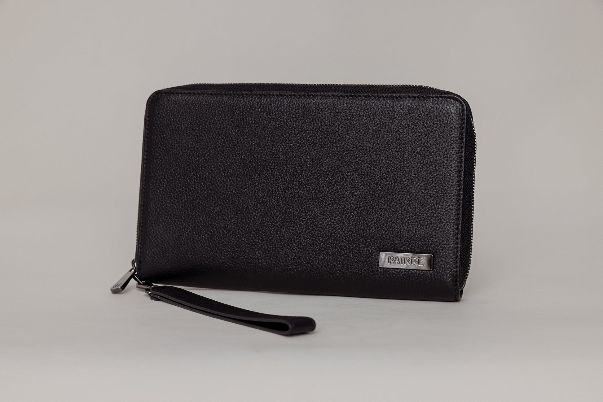 Pairre 4P passport wallet in black full-grain leather — closed exterior showing PVD gold hardware