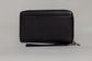 Pairre 4P passport wallet in black full-grain leather — closed exterior showing PVD gold hardware And exterior slip pocket