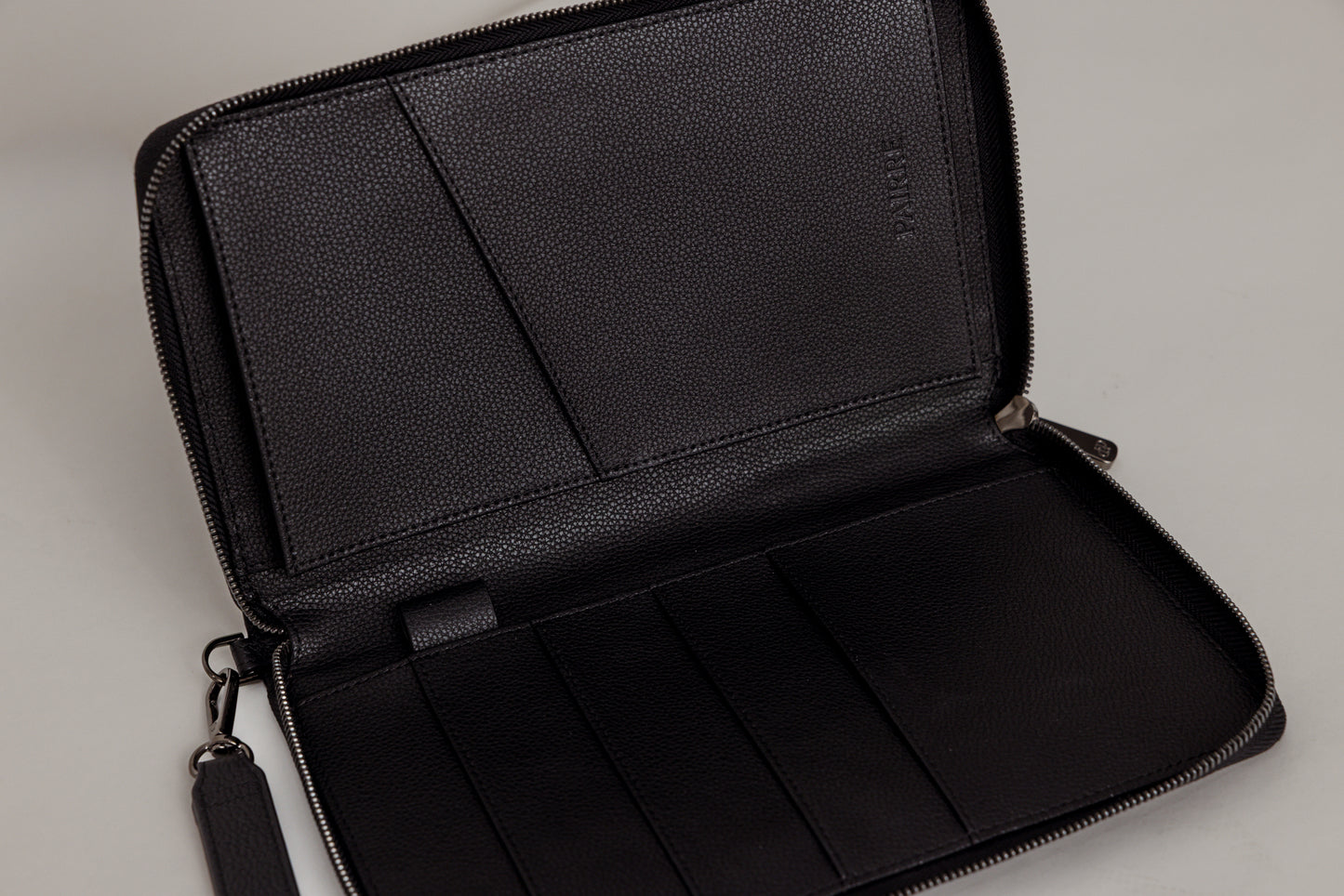 Pairre 4P passport wallet in black leather — open interior showing four passport slots and boarding pass pocket