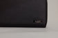 Pairre 4P black leather passport wallet — close up of PVD gold Pairre hardware plate