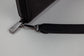 Pairre 4P black leather passport wallet — close up of PVD gold Pairre hardware plate