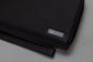 Pairre 4P black leather passport wallet — close up of PVD gold Pairre hardware plate
