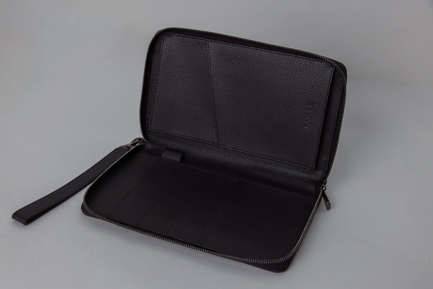 Pairre 4P passport wallet in black leather — open interior showing four passport slots and boarding pass pocket