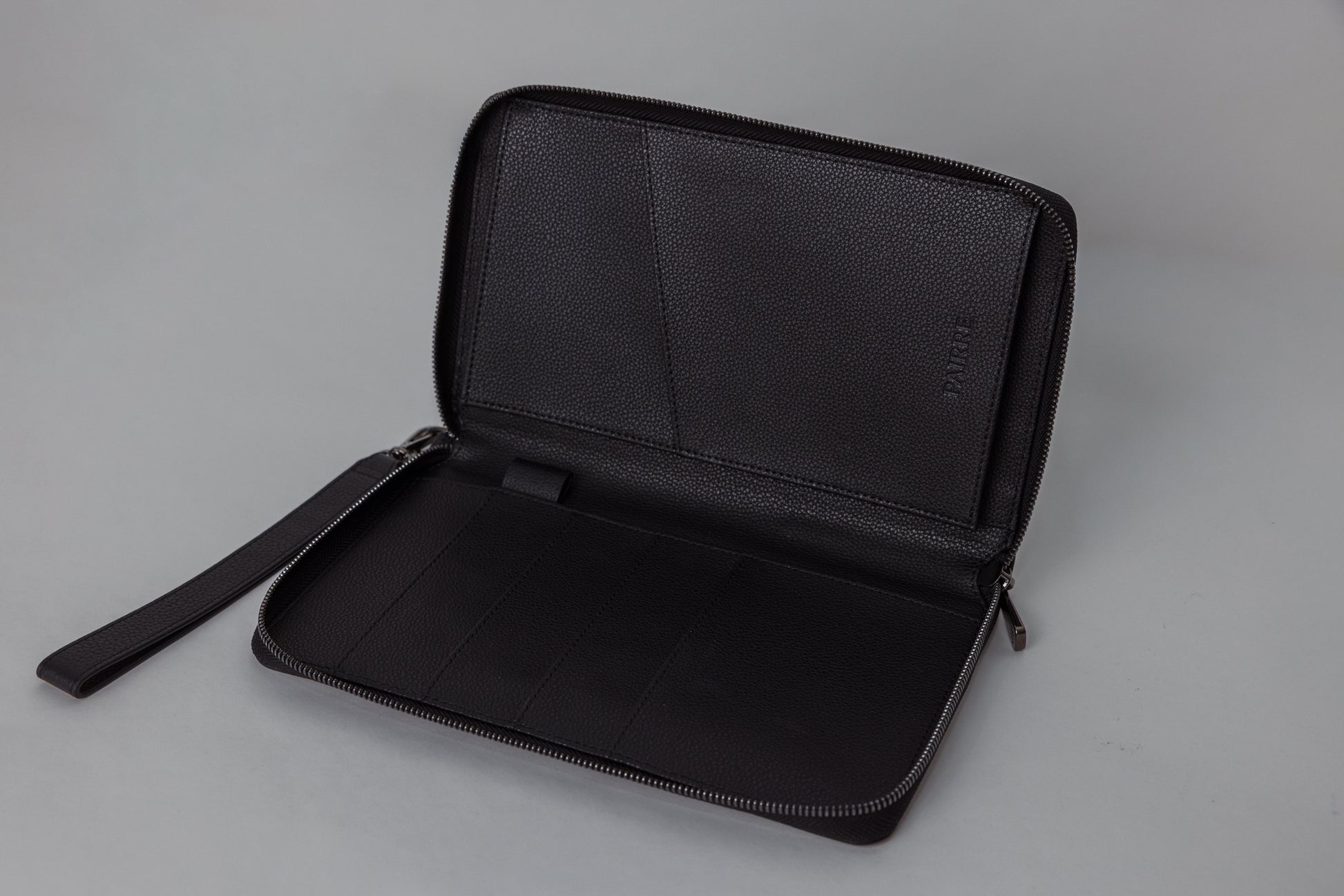 Pairre 4P passport wallet in black leather — open interior showing four passport slots and boarding pass pocket