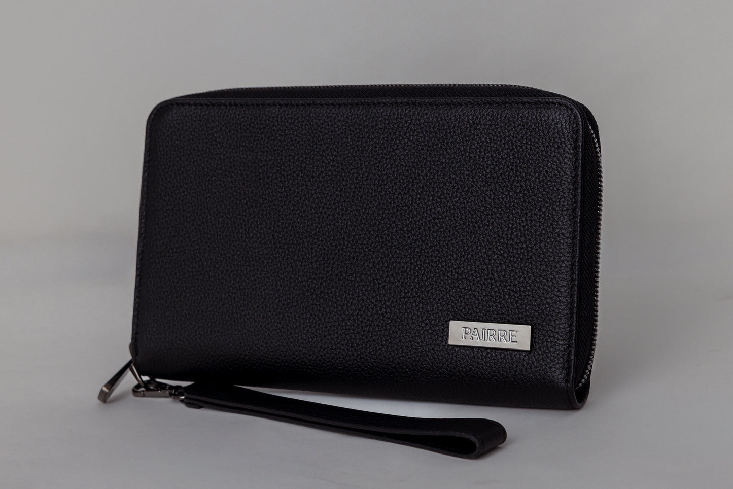 Pairre 2P black leather passport wallet - close up of PVD gold Pairre hardware plate