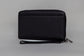 Pairre 2P passport wallet in black full-grain leather - closed exterior showing PVD gold hardware