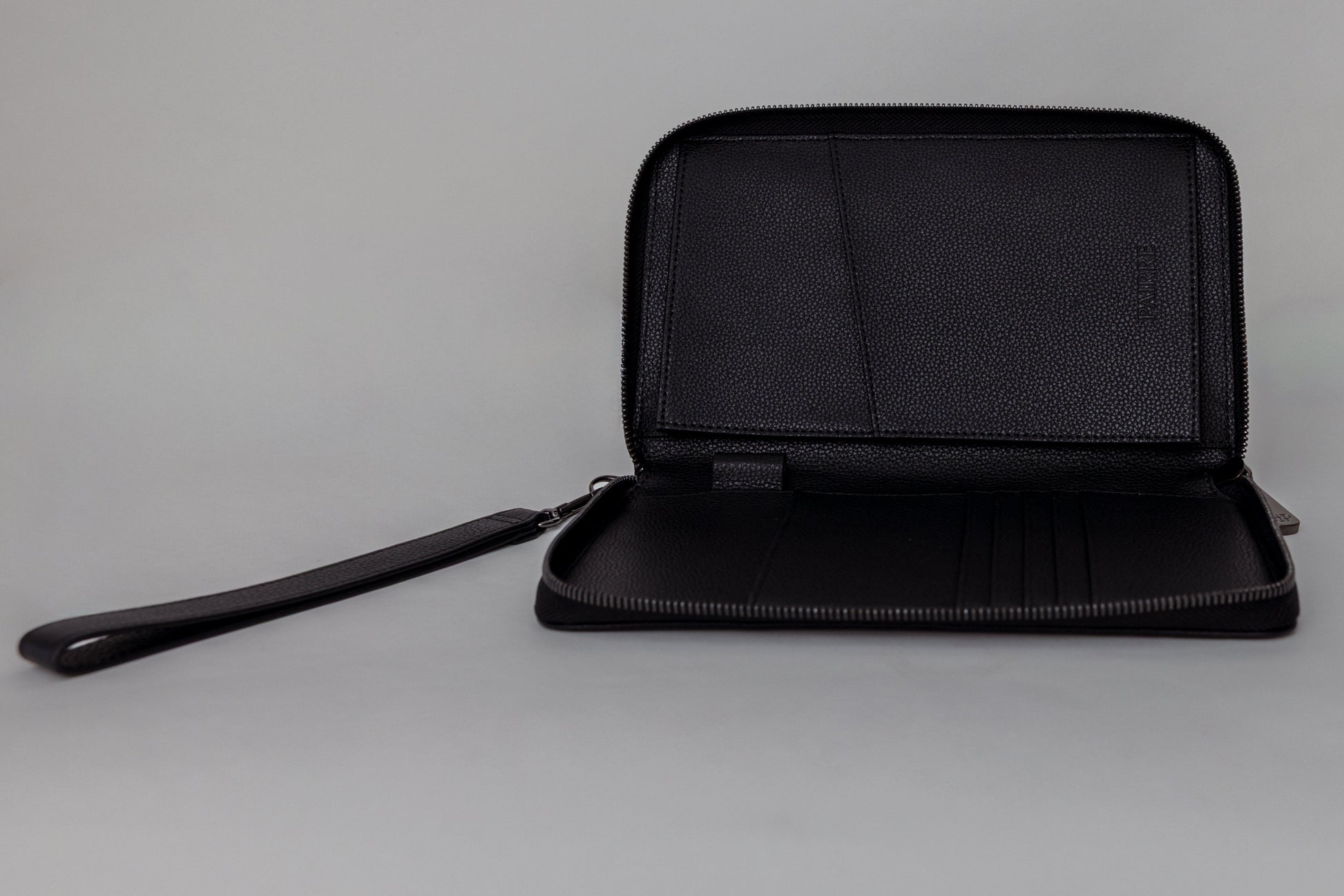 Pairre 2P passport wallet in black leather - open interior showing passport slots and card pockets