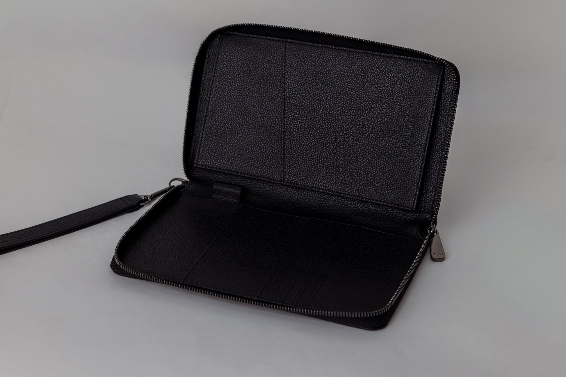 Pairre 2P passport wallet in black leather - open interior showing passport slots and card pockets