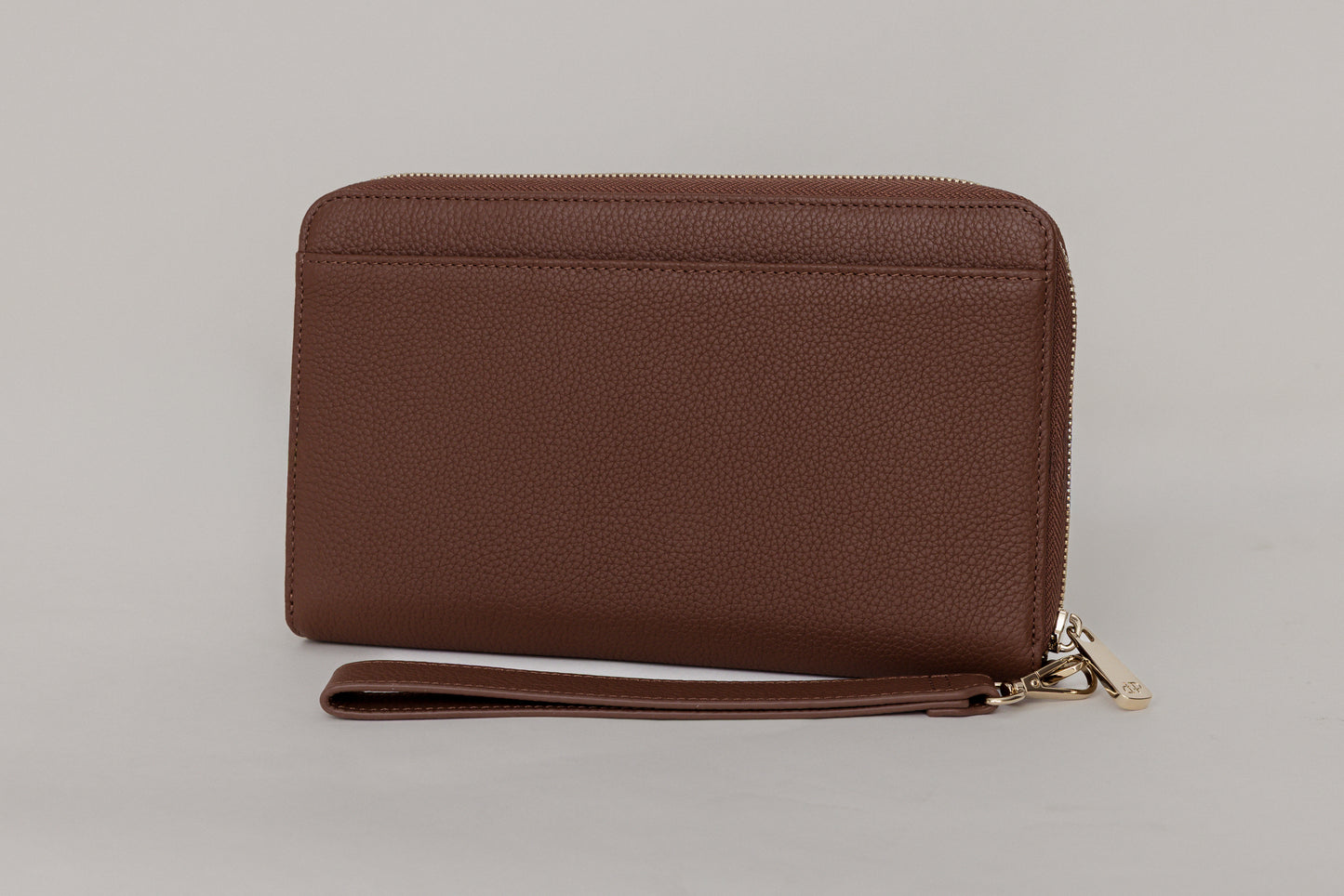 Pairre 2P passport wallet in brown full-grain leather - closed exterior showing PVD gold hardware