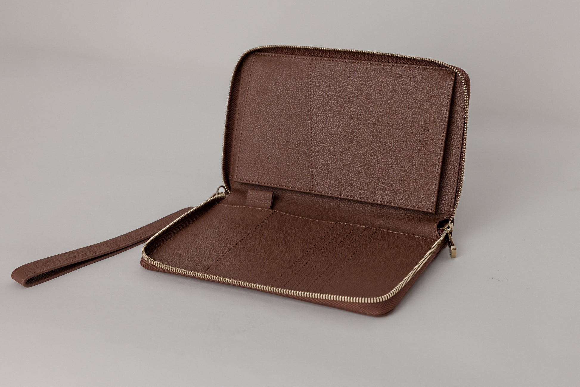 Pairre 2P passport wallet in brown leather - open interior showing passport slots and card pockets