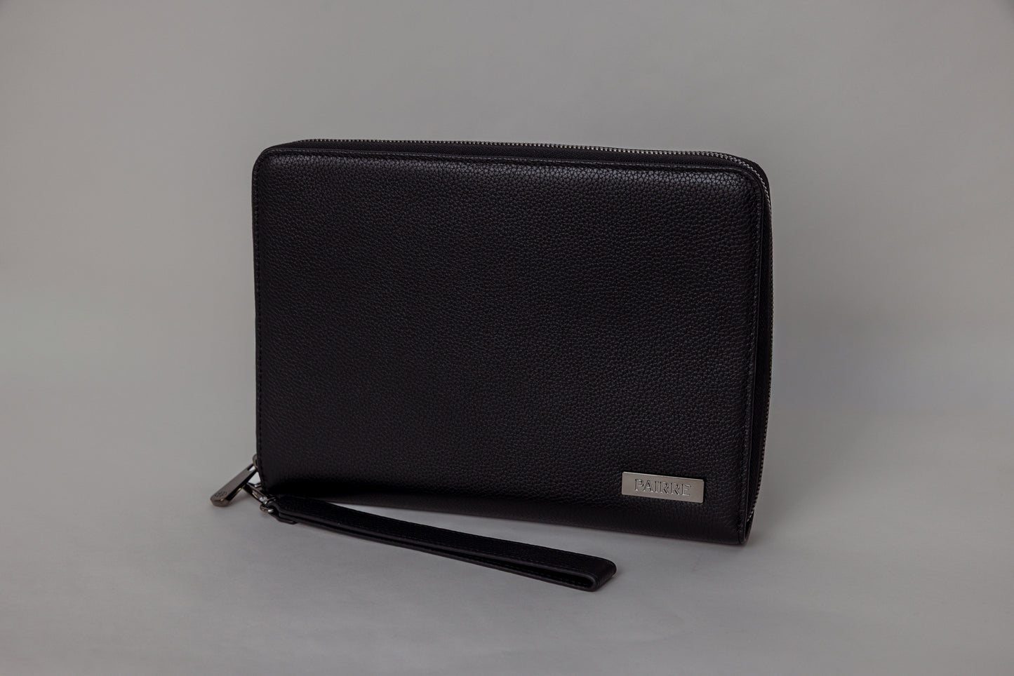 Pairre 8P passport wallet in black full-grain leather — closed exterior showing PVD gold hardware
