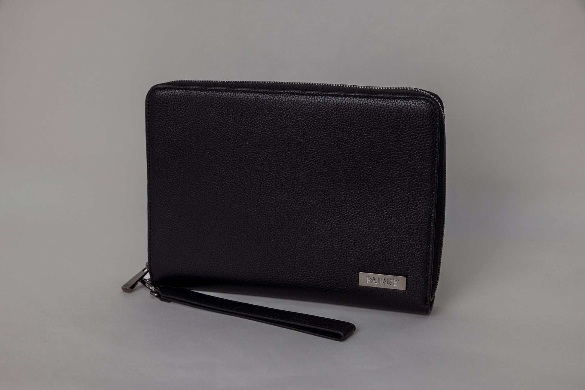 Pairre 8P passport wallet in black full-grain leather — closed exterior showing PVD gold hardware