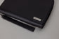 Pairre 8P black leather passport wallet — close up of PVD gold Pairre hardware plate