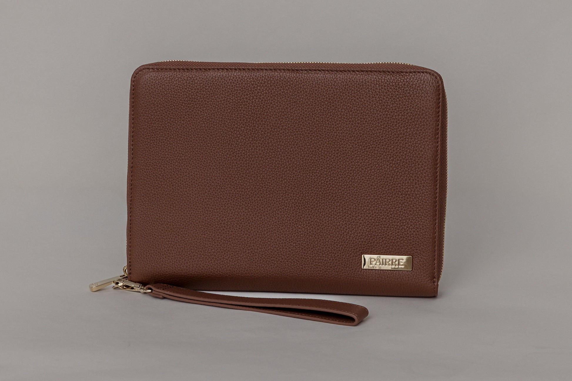 Pairre 8P passport wallet in brown full-grain leather — closed exterior showing PVD gold hardware