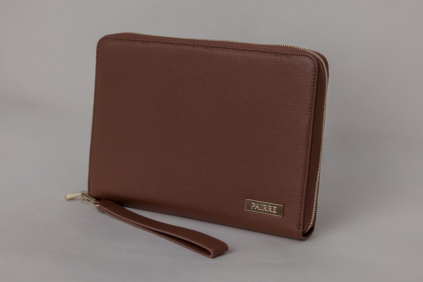Pairre 8P passport wallet in brown full-grain leather — closed exterior showing PVD gold hardware