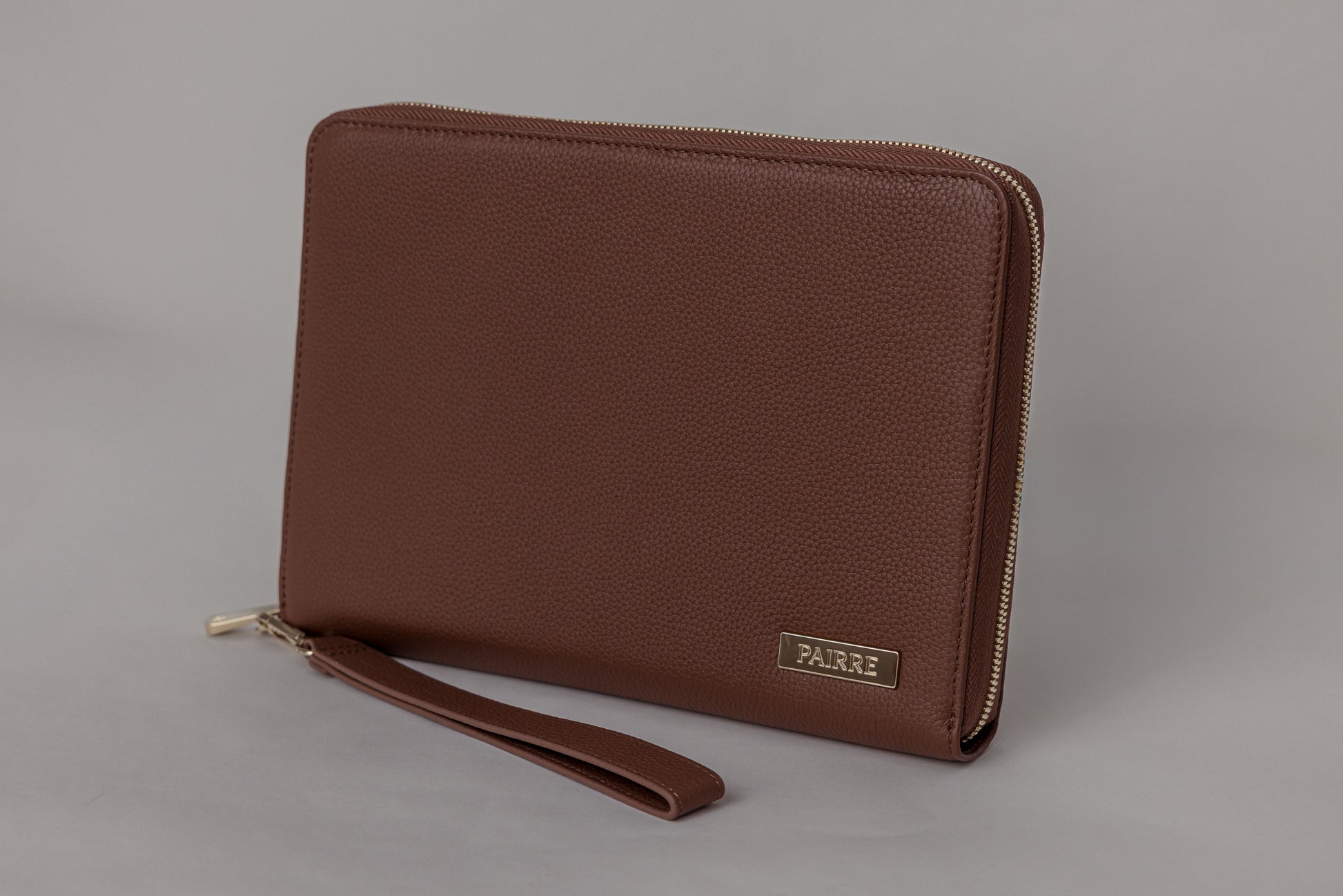 Pairre 8P passport wallet in brown full-grain leather — closed exterior showing PVD gold hardware