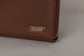 Pairre 8P brown leather passport wallet — close up of PVD gold Pairre hardware plate