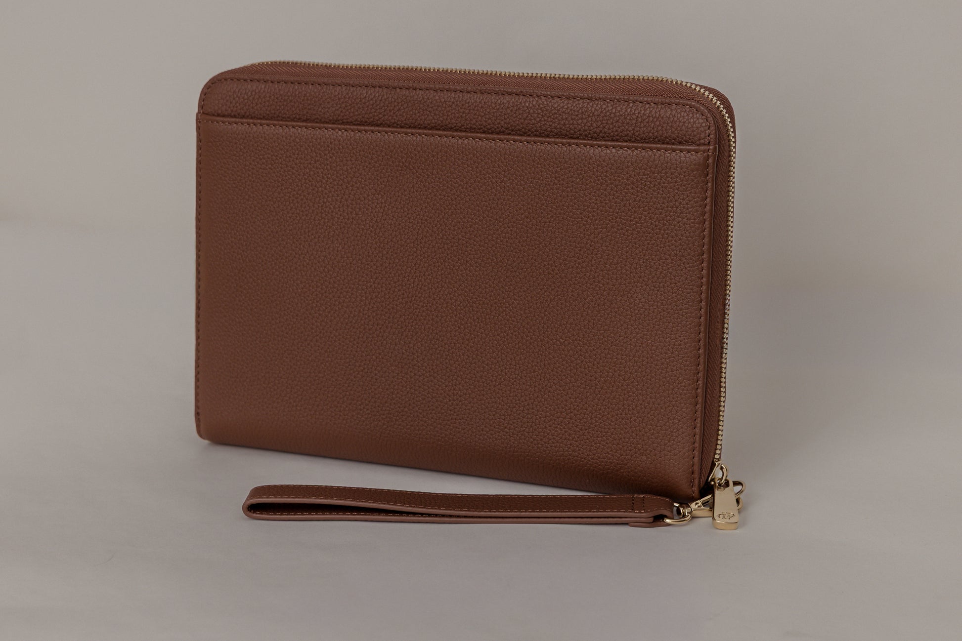 Pairre 8P passport wallet in brown/espresso full-grain leather — closed exterior showing PVD gold hardware - rear slip pocket