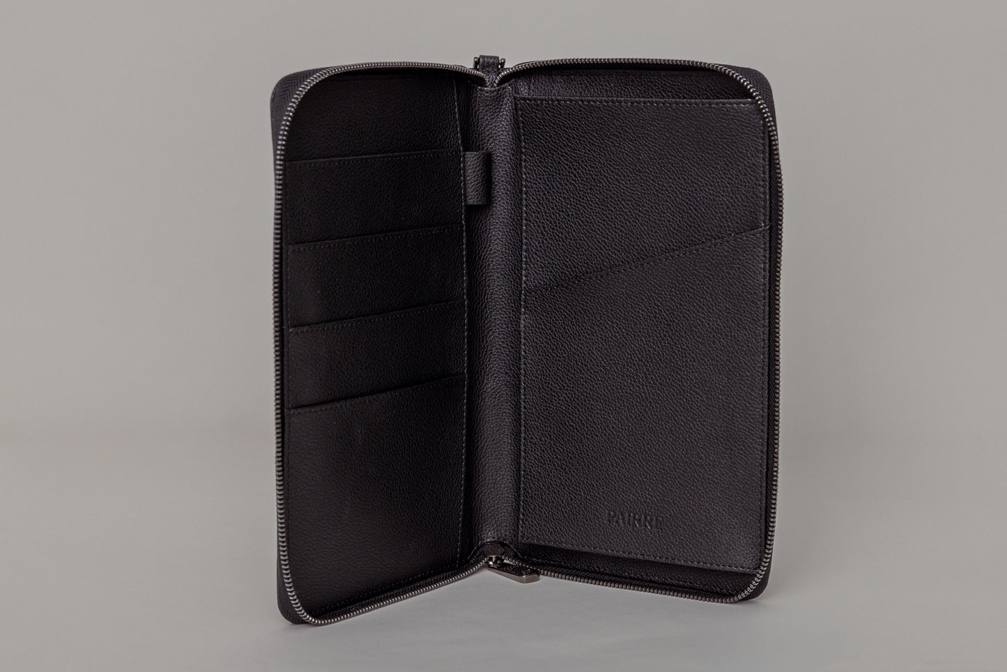 Pairre 4P passport wallet in black leather — open interior showing four passport slots and boarding pass pocket