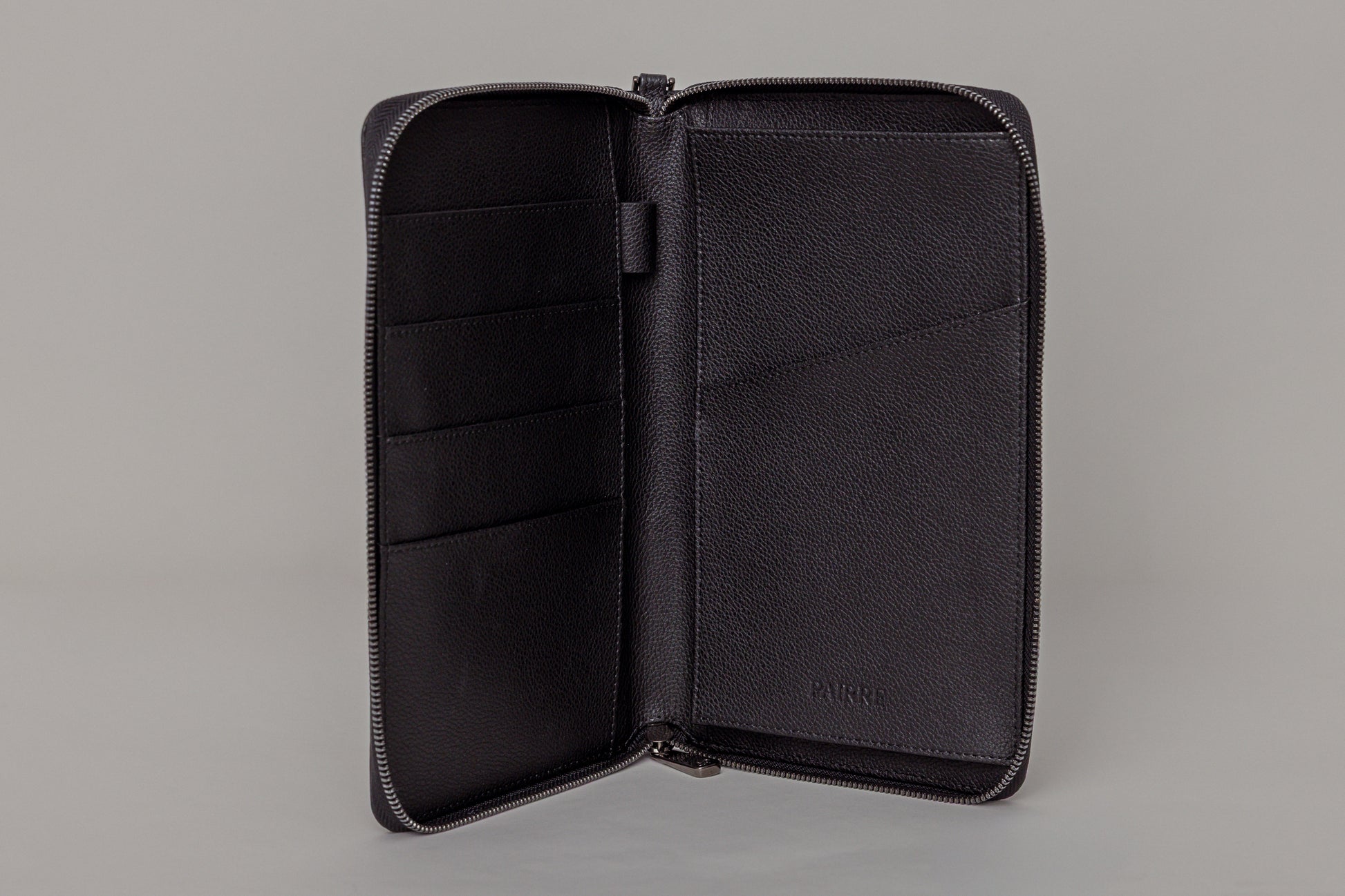 Pairre 4P passport wallet in black leather — open interior showing four passport slots and boarding pass pocket