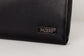 Pairre 8P black leather passport wallet — close up of PVD gold Pairre hardware plate