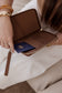Pairre 2P brown/espresso leather passport wallet with wrist strap - lifestyle shot