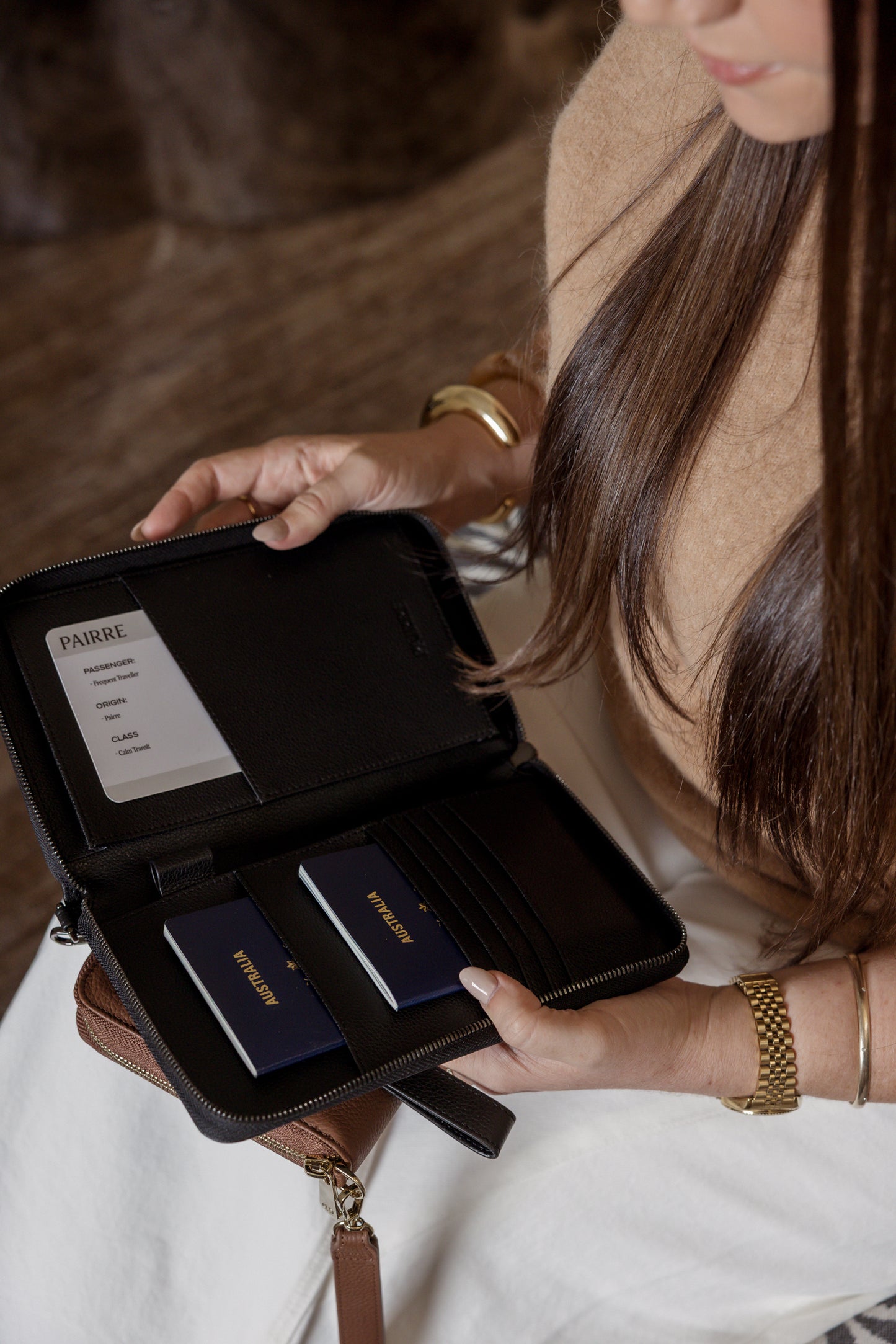 Pairre 2P black leather passport wallet with wrist strap - lifestyle shot