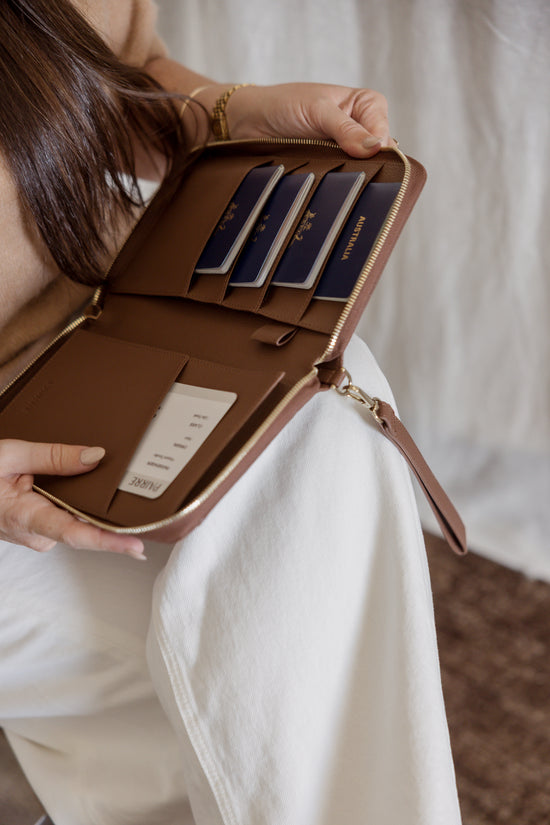 Pairre 4P brown/espresso leather passport wallet held by founder Bridget -  lifestyle shot