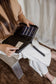 Pairre 4P black leather passport wallet held by founder Bridget - lifestyle shot