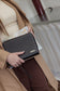 Pairre 8P black leather passport wallet — lifestyle shot with wrist strap - travel wallet