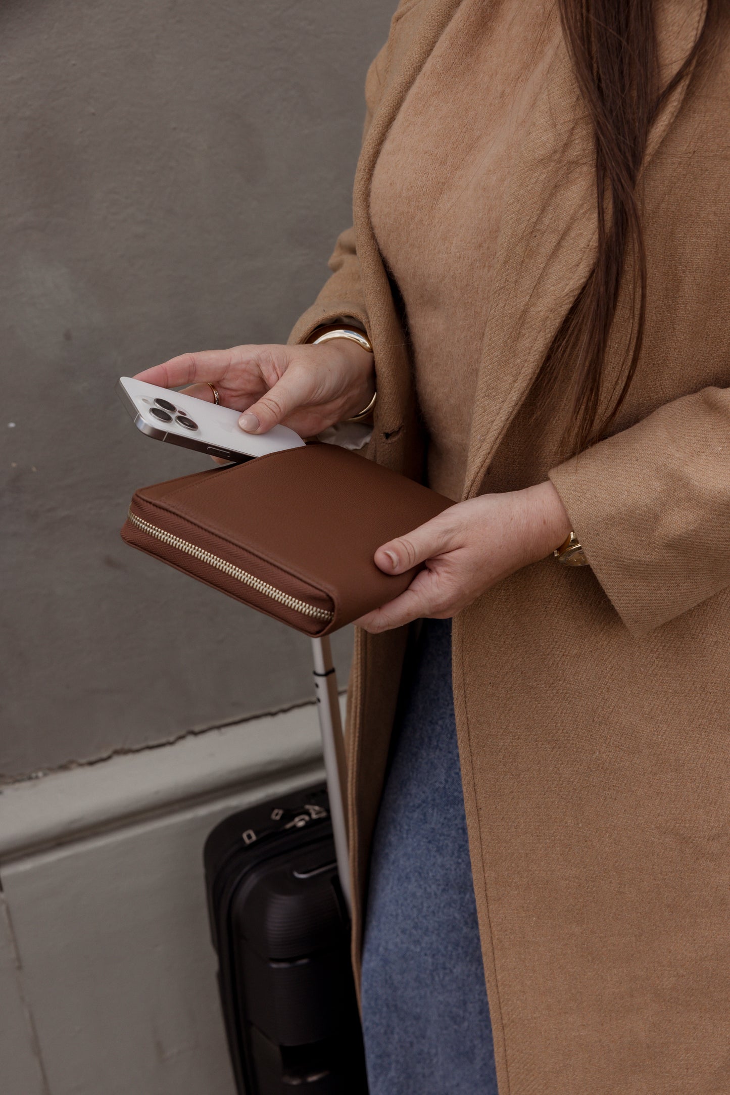 Pairre 8P brown leather passport wallet — lifestyle shot with rear lip pocket