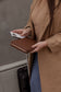 Pairre 8P brown leather passport wallet — lifestyle shot with rear lip pocket