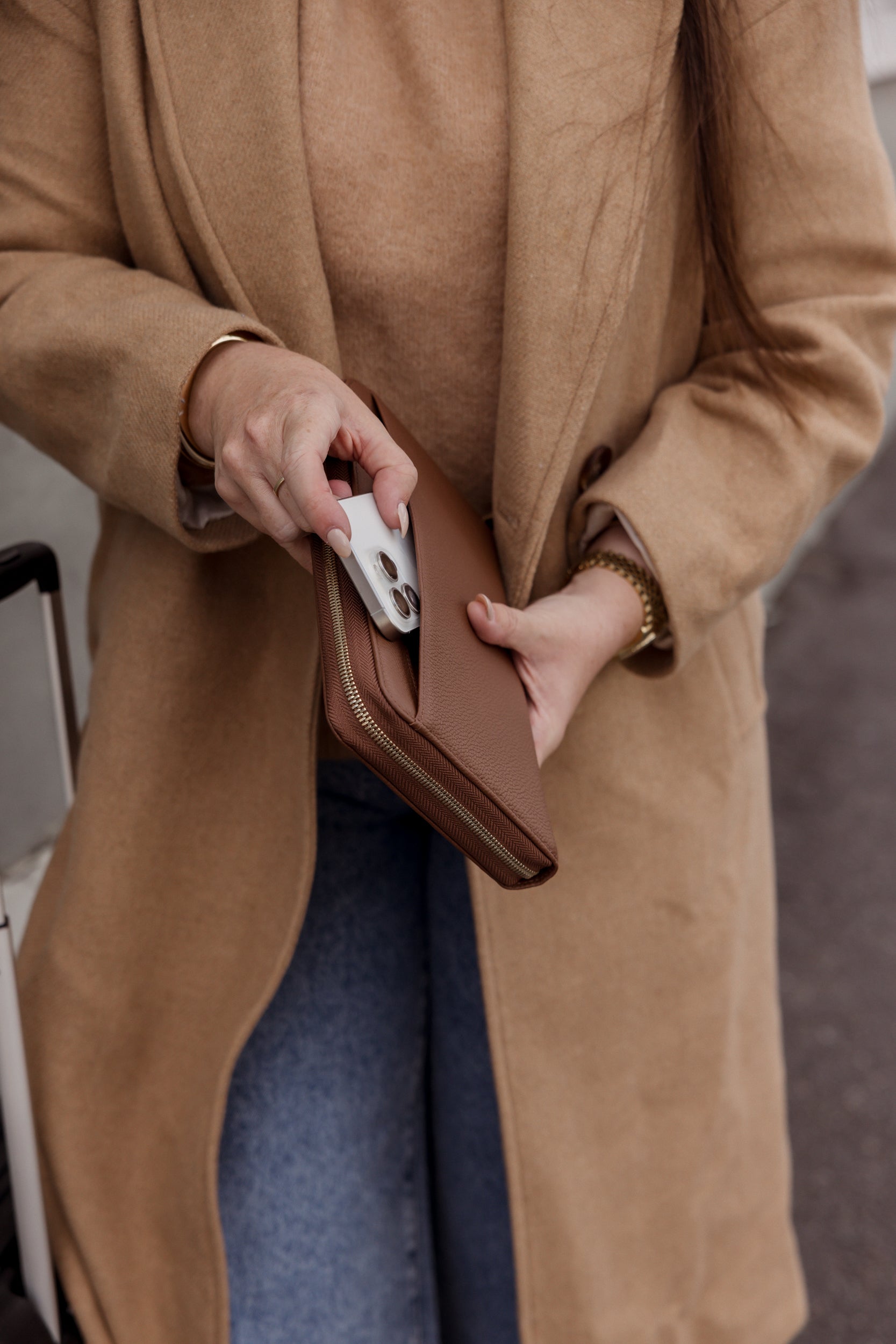 Pairre 4P brown/espresso leather passport wallet held by founder Bridget - lifestyle shot