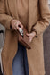Pairre 4P brown/espresso leather passport wallet held by founder Bridget - lifestyle shot