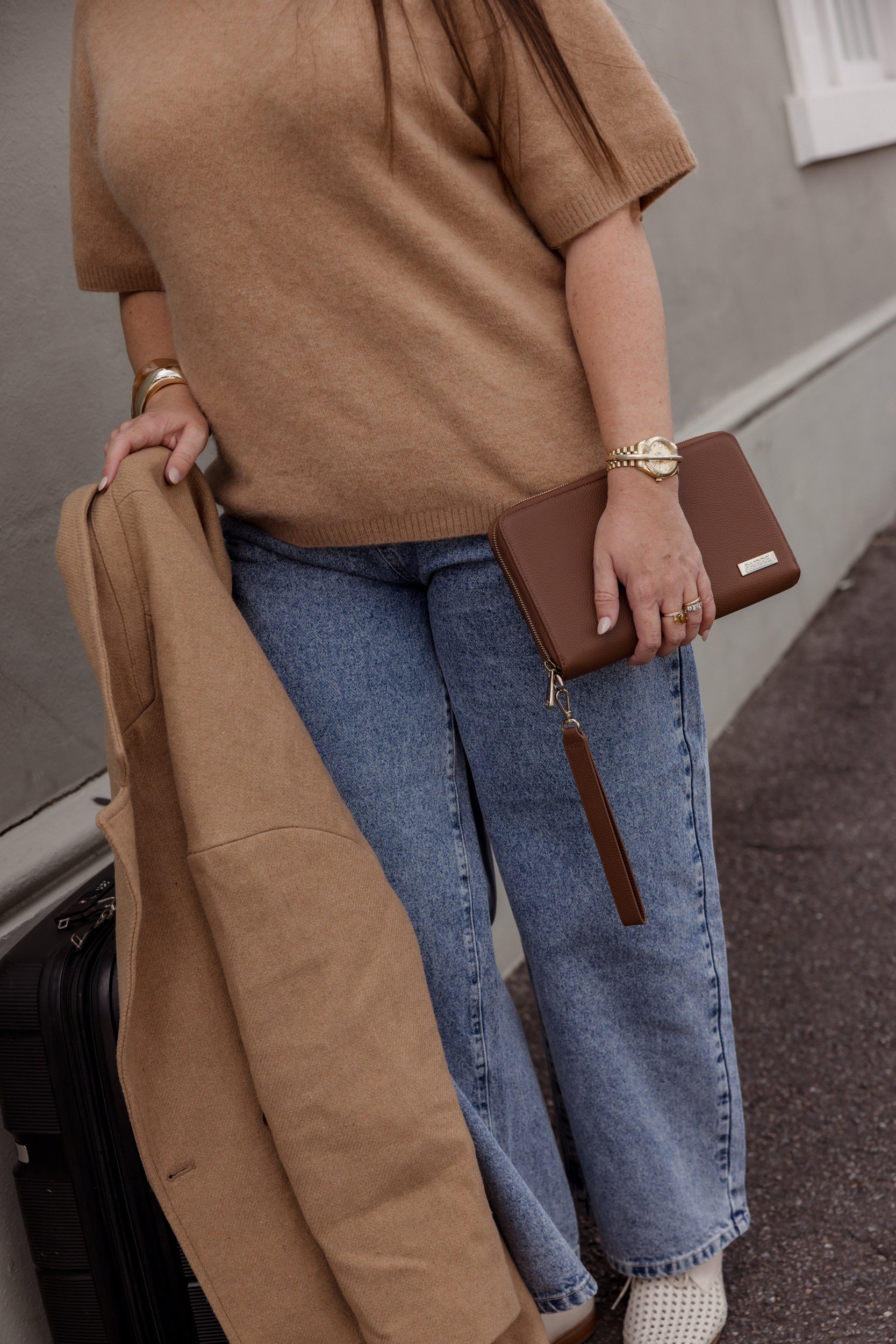 Pairre 4P brown/espresso leather passport wallet held by founder Bridget - lifestyle shot