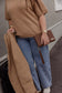 Pairre 4P brown/espresso leather passport wallet held by founder Bridget - lifestyle shot